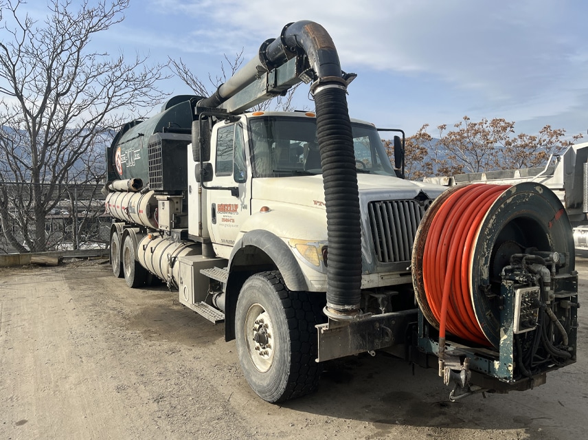 A truck equipped with a hose, ready for use in various applications such as firefighting or construction