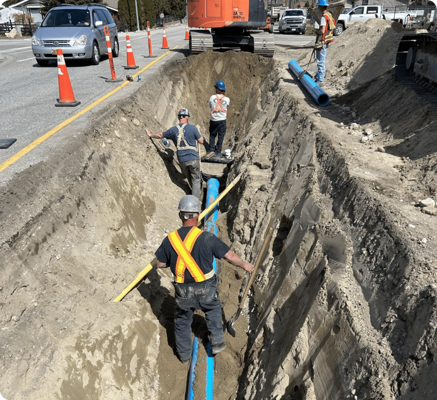 Workers diligently installing pipes in a construction site, ensuring proper alignment and secure fittings for infrastructure