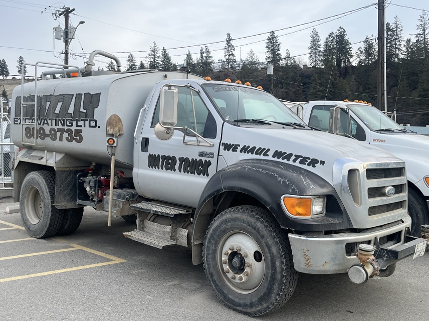 A large truck equipped with a substantial water tank, ready for transportation or irrigation purposes.